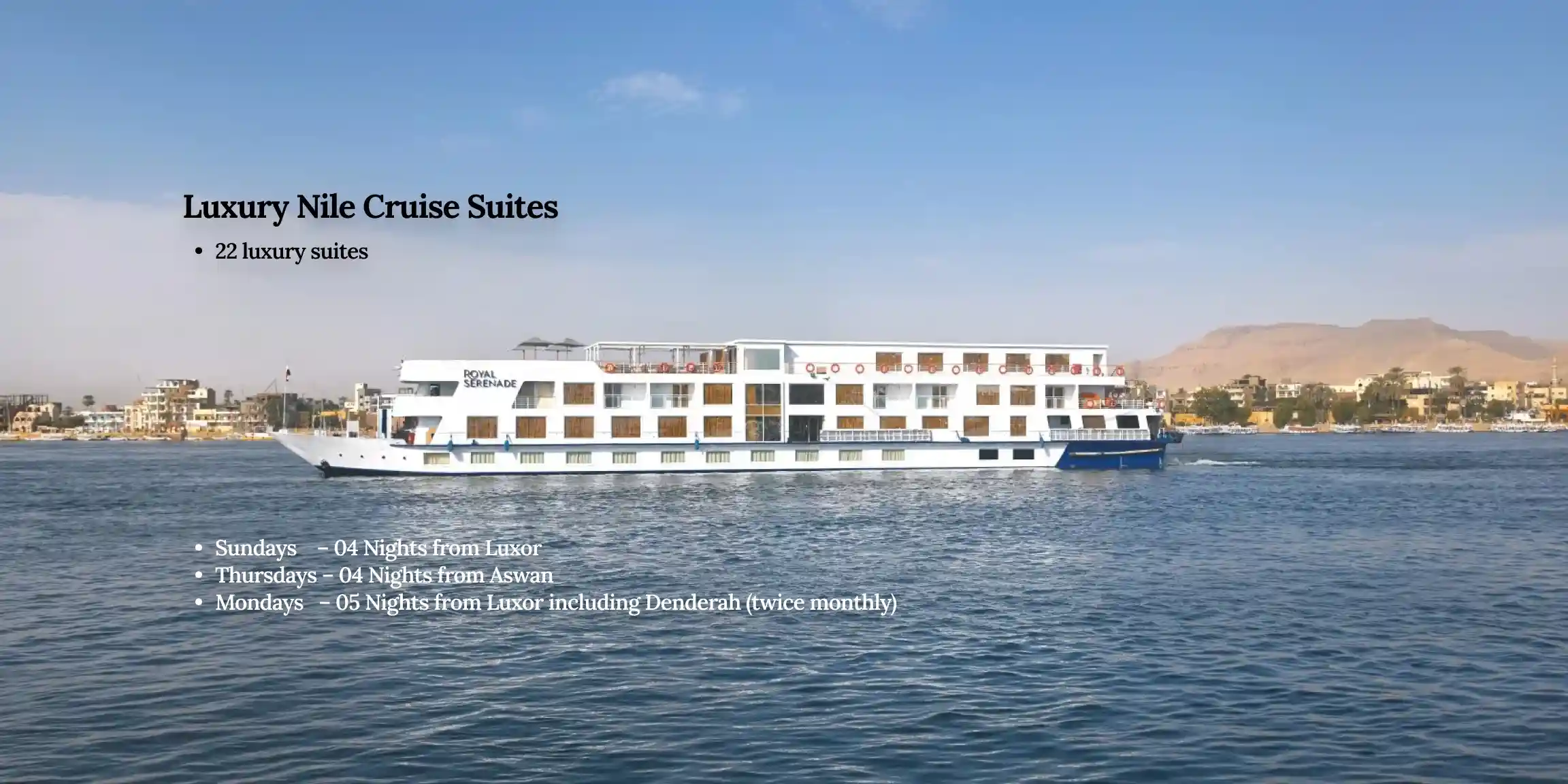 An elegant luxury Nile cruise suite featuring a comfortable bed, large panoramic windows with views of the river, and premium interior decor.
