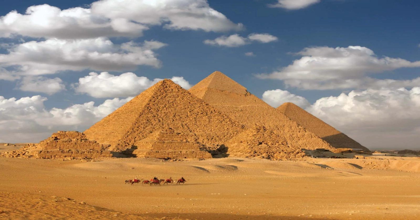 Panoramic view of the Great Pyramids of Giza at sunset, a highlight of the 7-Day Nile Majesty & Cairo Wonders tour.