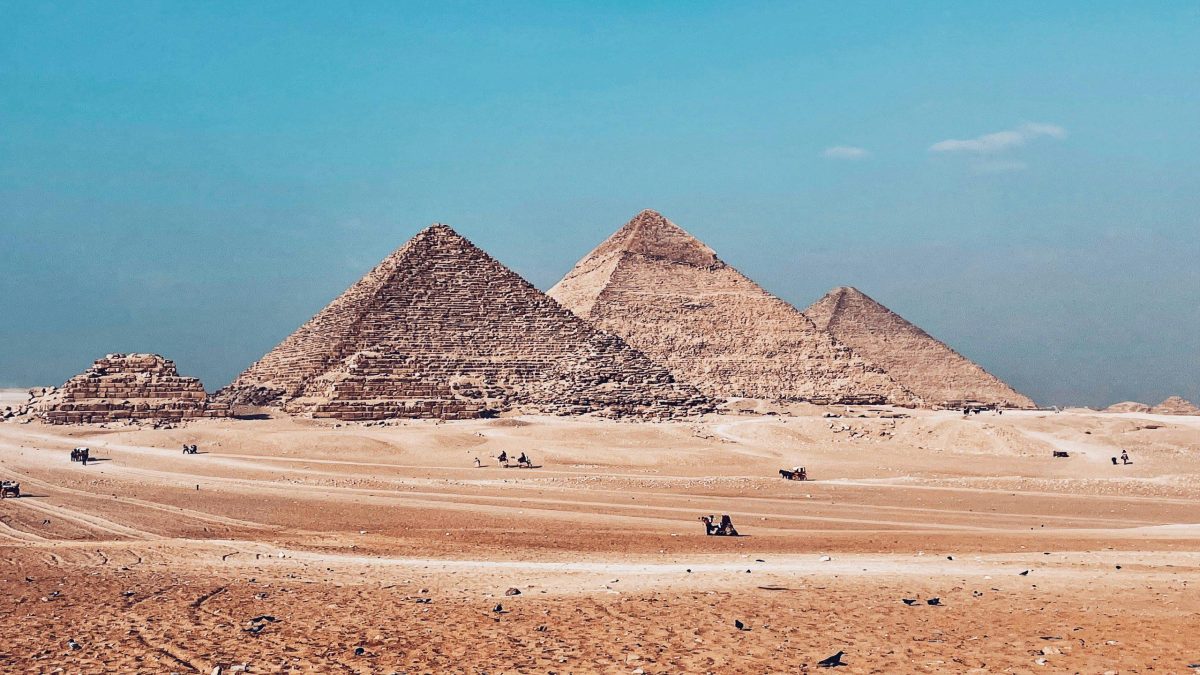 A luxury Nile cruise ship docked near ancient Egyptian temples during a 10-day Royal Egypt Odyssey tour featuring Cairo and Alexandria.