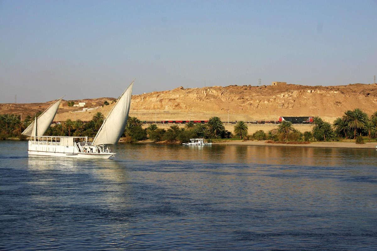 Dahabiya Nile cruise sailing on the river Nile under a clear blue sky in Egypt