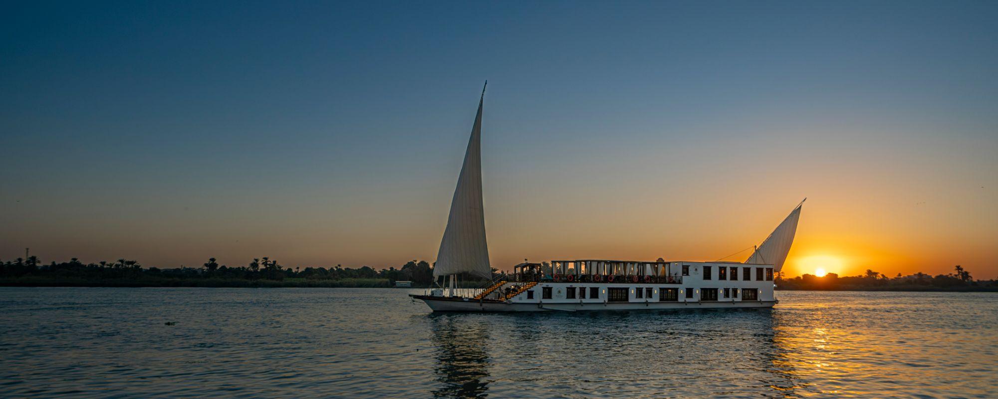 Small wooden Dahabiya boat on the water.