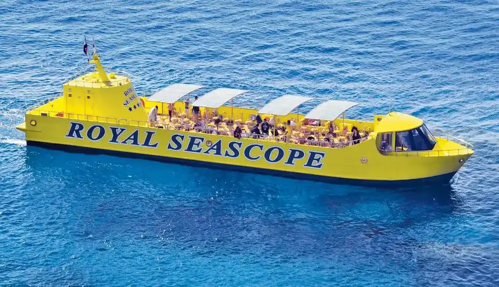 Families looking through the large glass windows of the Royal Seascope Submarine in Marsa Alam.