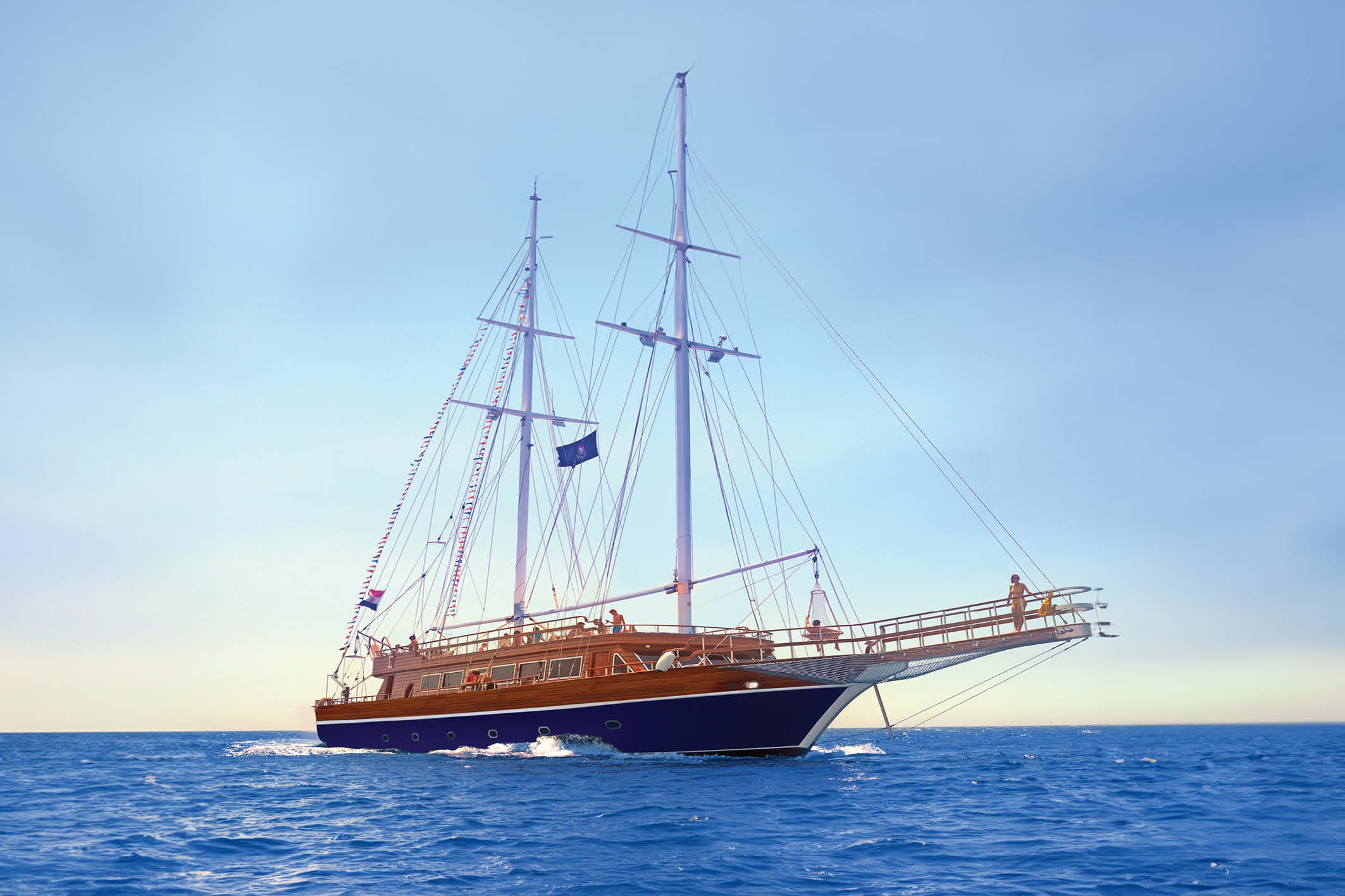 Pirates Sailing Boat in Marsa Alam cruising over the Red Sea with passengers snorkeling and relaxing on deck.
