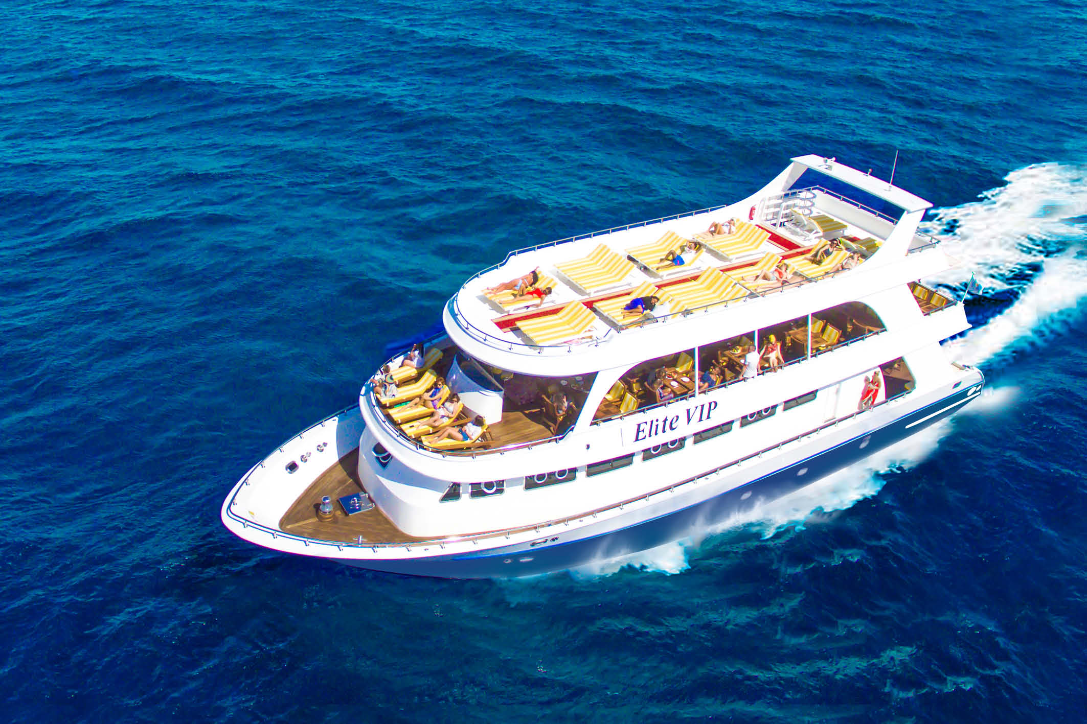 Luxury Elite VIP Cruise boat in Marsa Alam sailing over the Red Sea with passengers snorkeling and relaxing on deck.
