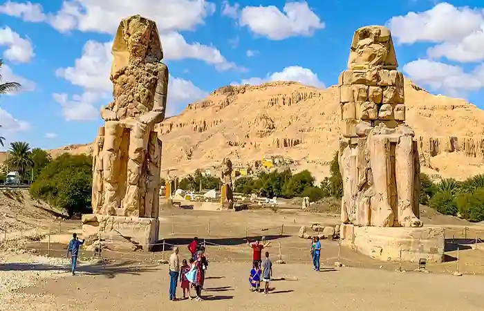 Colossi of Memnon statues on Luxor West Bank, giant seated statues of Amenhotep III in Egypt