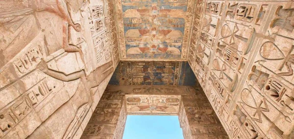 Vibrant ancient Egyptian wall carvings and colorful hieroglyphs at Medinet Habu Temple in Luxor, organized by MSM Travel Egypt.
