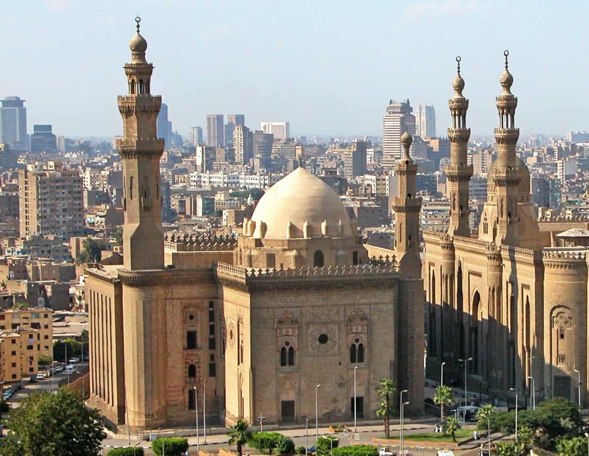 Wide view of the central courtyard and marble fountain of the Sultan Hassan Mosque and Madrasa in Cairo, Egypt.