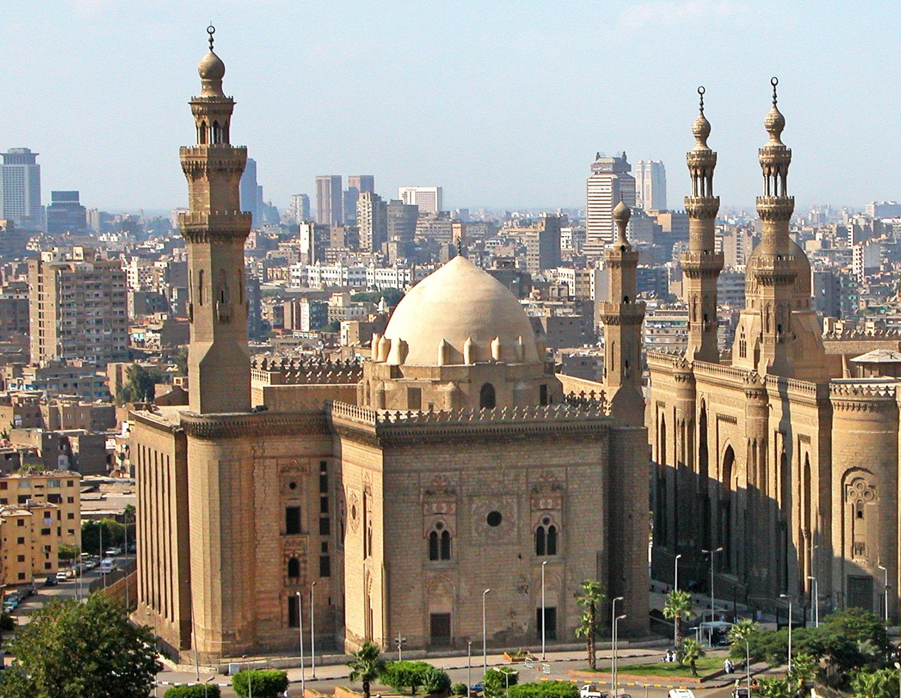Wide view of the central courtyard and marble fountain of the Sultan Hassan Mosque and Madrasa in Cairo, Egypt.