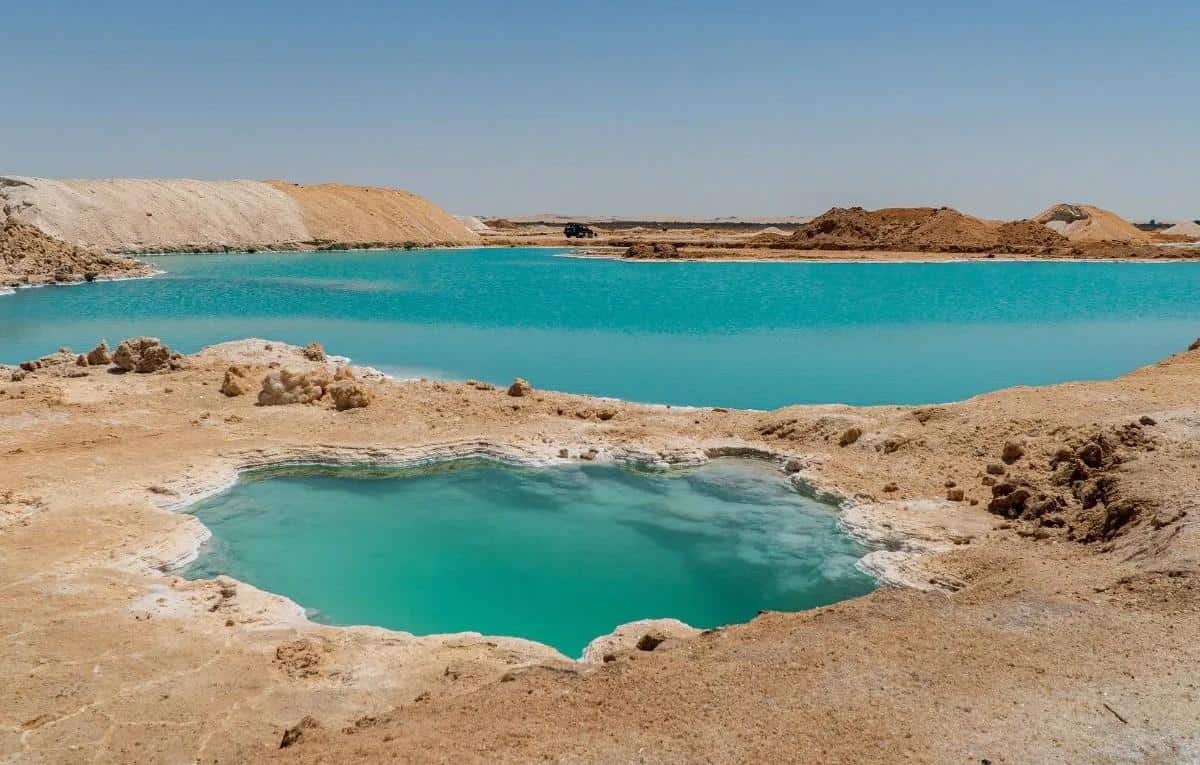 Siwa Oasis in Egypt A person floating in the turquoise Siwa Salt Lakes in Egypt’s Western Desert.