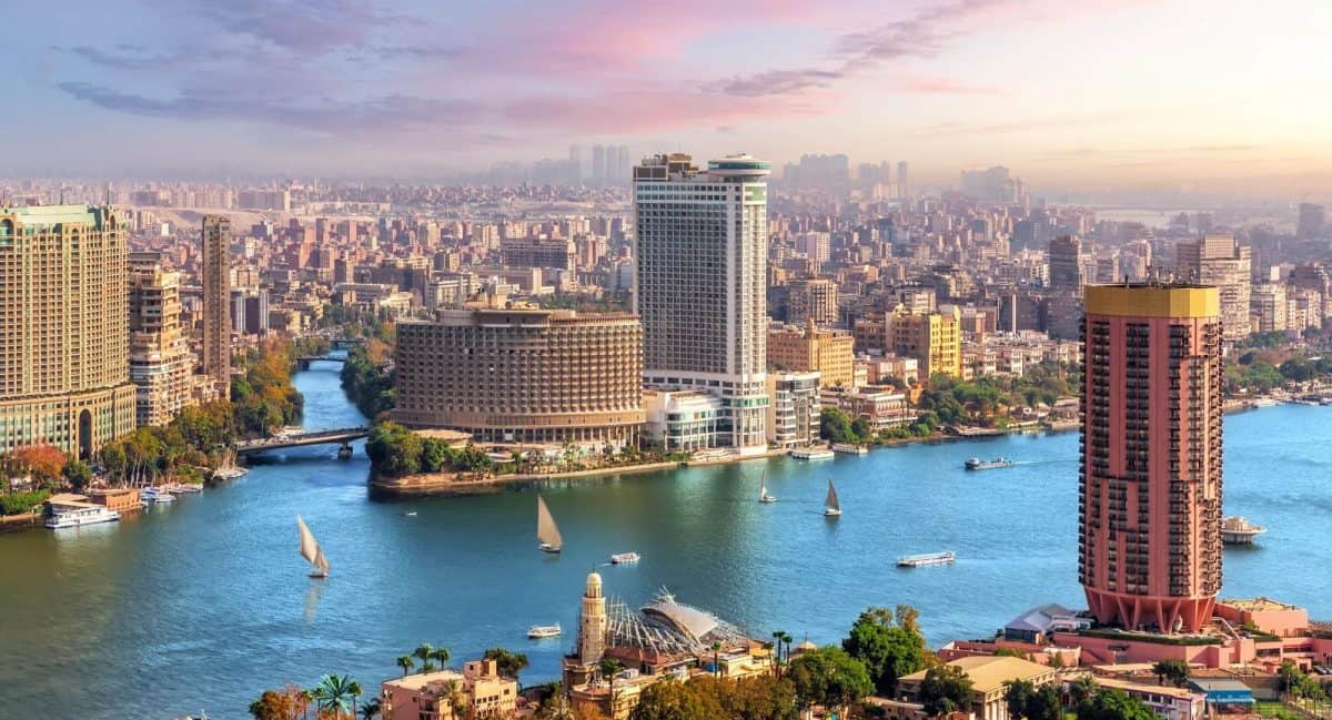 Aerial view of the Nile River in Cairo with luxury hotels and feluccas by MSM Travel Egypt.
