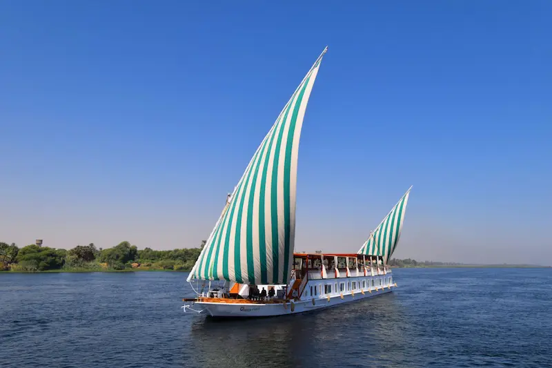 Boutique Dahabiya Nile cruise boat with large sails on the Nile River