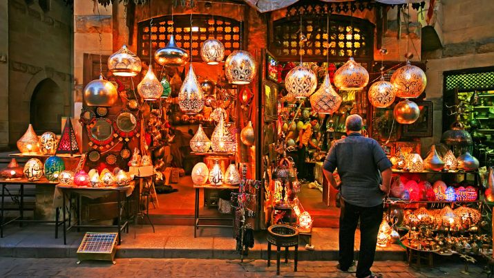 A vibrant alley in Khan El Khalili bazaar Cairo with brass lanterns and traditional Egyptian souvenirs
