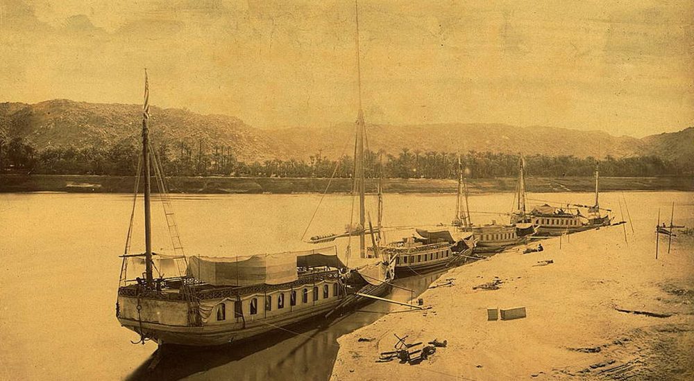 Traditional Dahabiya sailing boat on the Nile River in Egypt during sunset