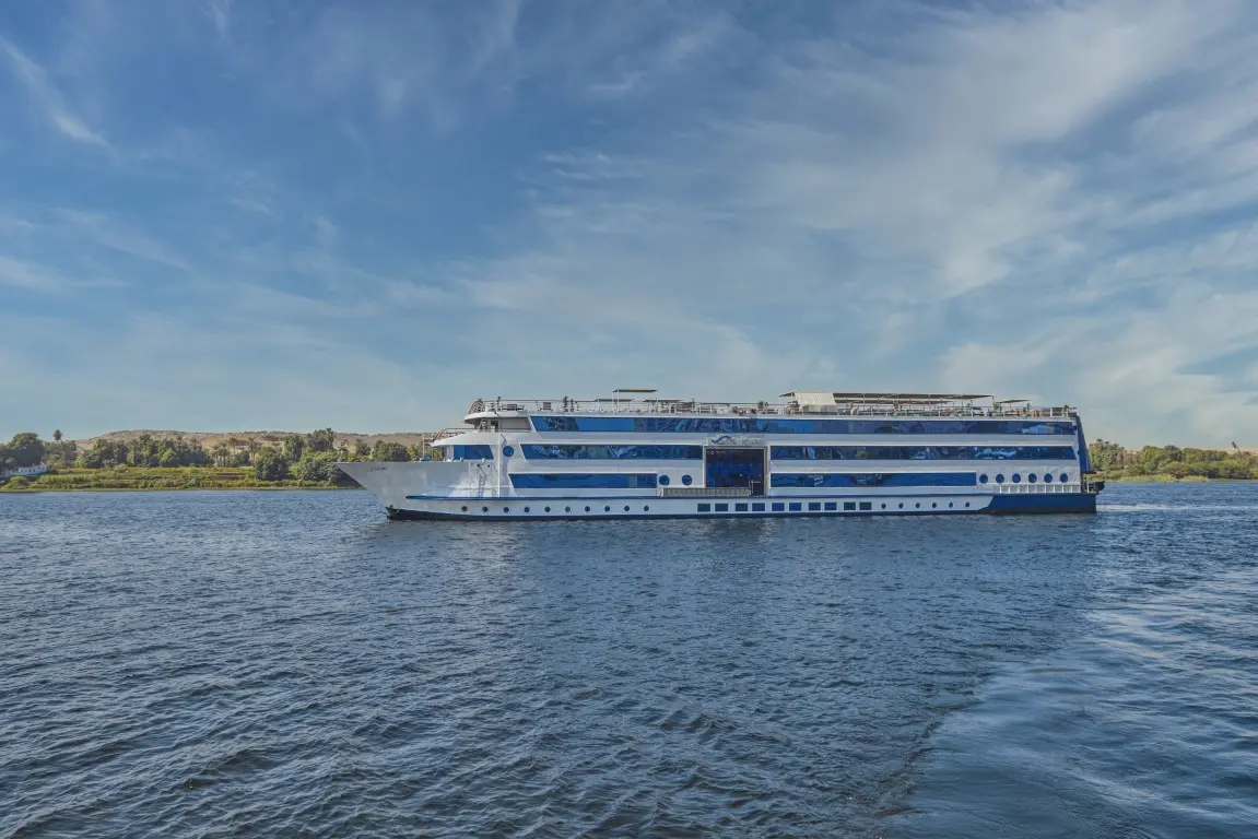 A luxury cruise ship sailing along the Nile River in Egypt at sunset, illustrating key answers for traveler inquiries.