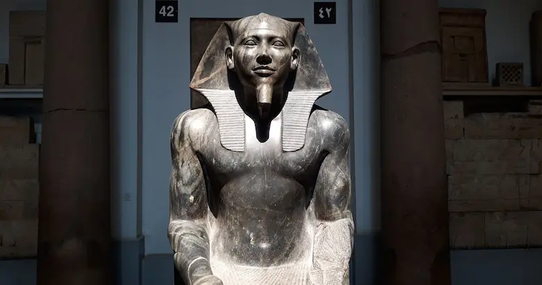 Seated diorite statue of Pharaoh Khafre wearing a nemes headdress at the Egyptian Museum in Cairo.