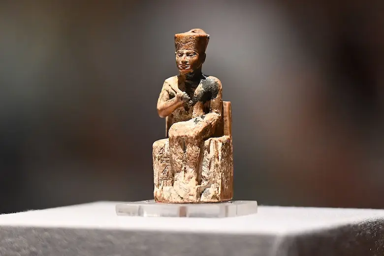 Small ivory statuette of Pharaoh Khufu seated on a throne, on display at the Egyptian Museum in Cairo.