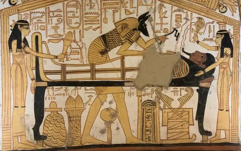 Labeled diagram showing the step-by-step process of mummification in ancient Egypt with embalming jars and linen wraps