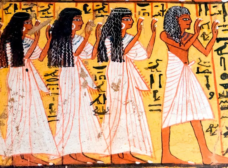 Ancient Egyptian tomb painting depicting three women in fine white pleated linen dresses and a man in a pleated kilt wearing dark wigs.