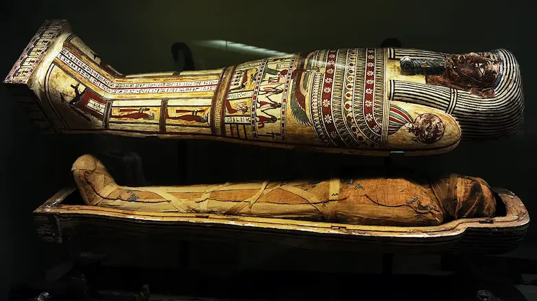 Ancient Egyptian mummy resting inside a decorated sarcophagus representing why Egyptians mummified the dead
